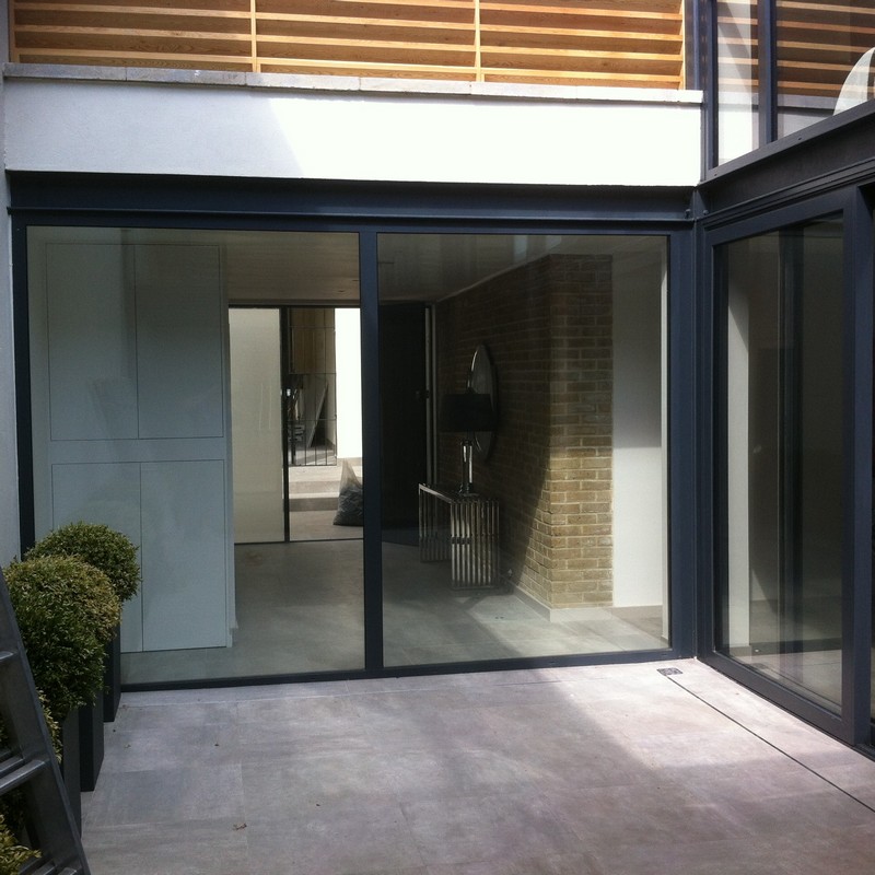 Floor-to-ceiling sliding doors opening to courtyard in Merton
