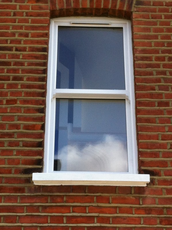 uPVC sash window on Victorian red brick house in Merton
